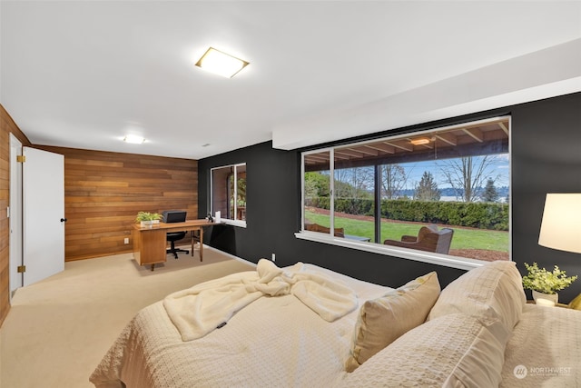 bedroom featuring carpet floors and wooden walls