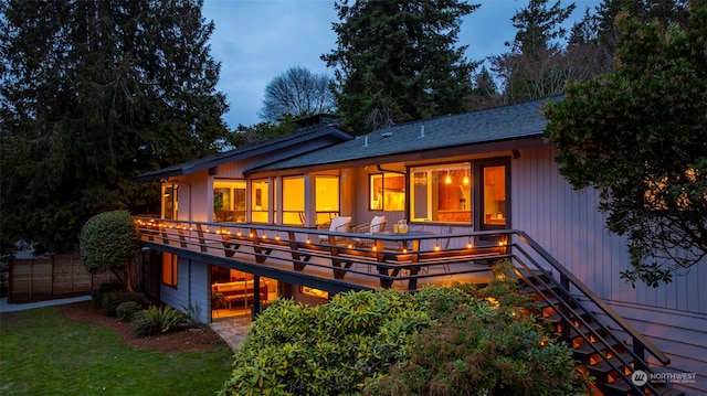 view of back house at dusk