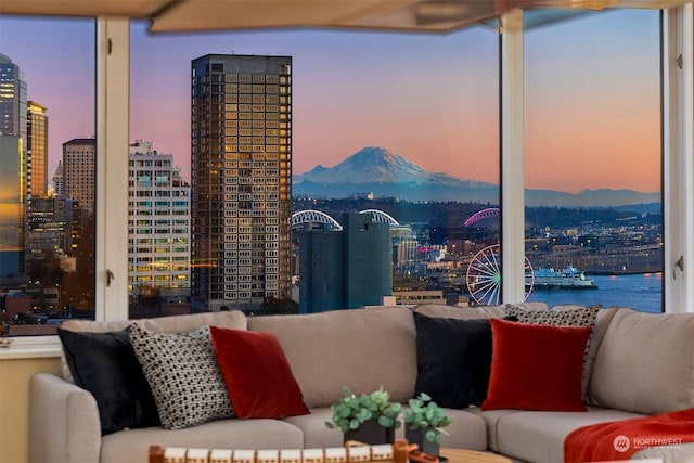 living room with floor to ceiling windows and a water and mountain view