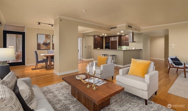 living room with crown molding and light hardwood / wood-style floors