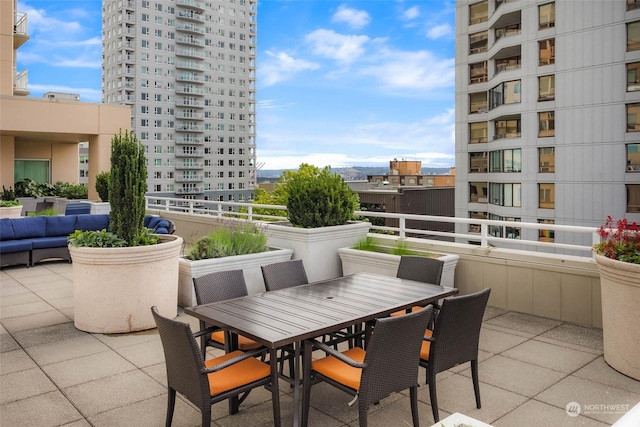 view of patio featuring a balcony and an outdoor hangout area