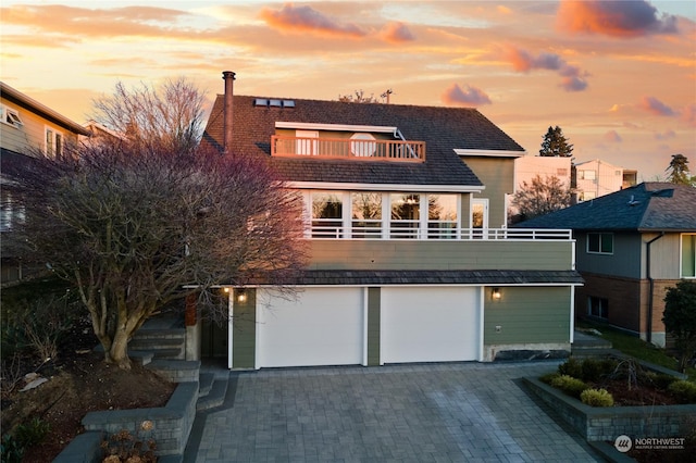 view of front facade featuring a balcony and a garage