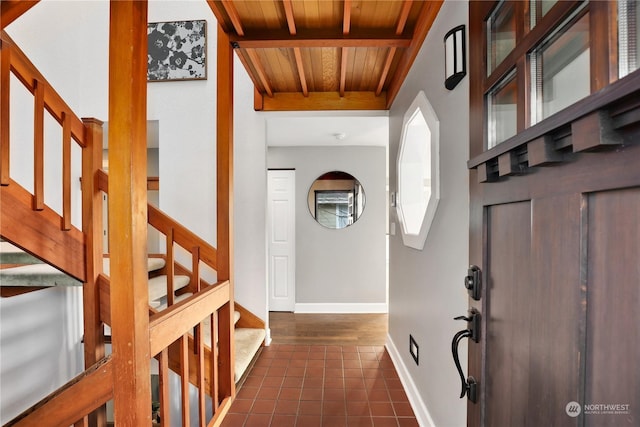 tiled entrance foyer featuring wood ceiling and beam ceiling