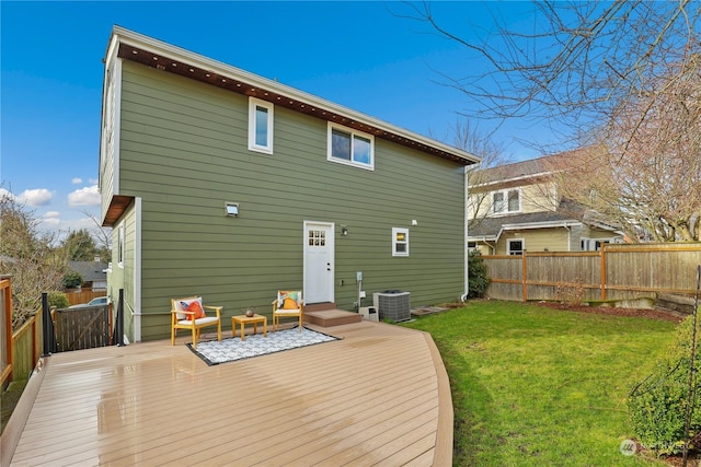 back of house featuring outdoor lounge area, a deck, central air condition unit, and a lawn