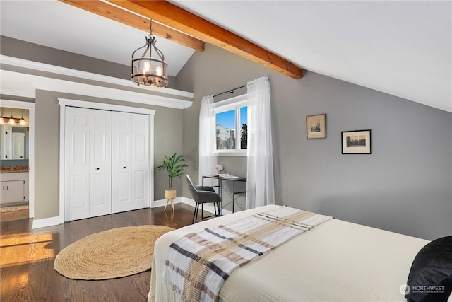 bedroom featuring a notable chandelier, dark wood-type flooring, lofted ceiling with beams, and a closet