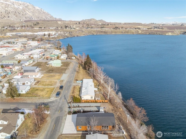 bird's eye view with a water and mountain view