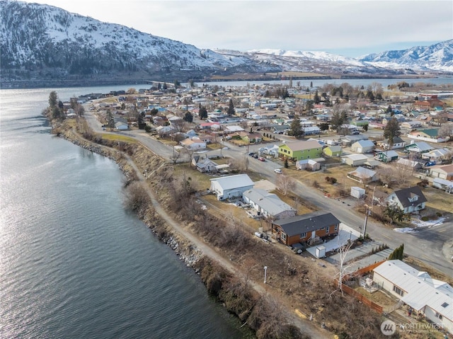 drone / aerial view featuring a water and mountain view