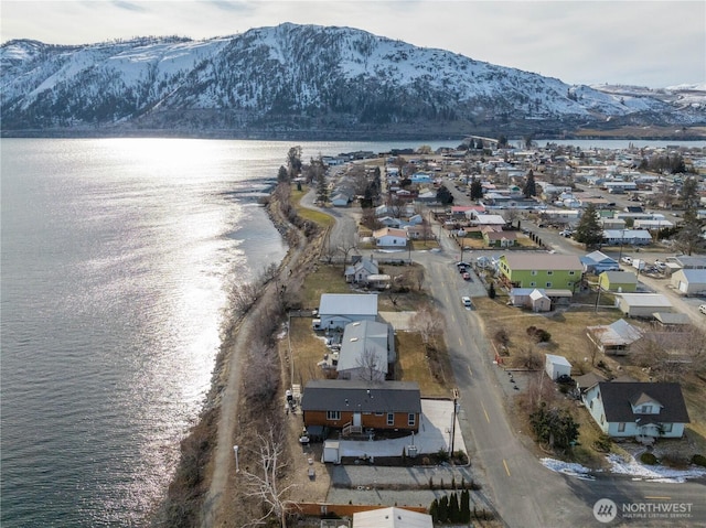 birds eye view of property featuring a water and mountain view