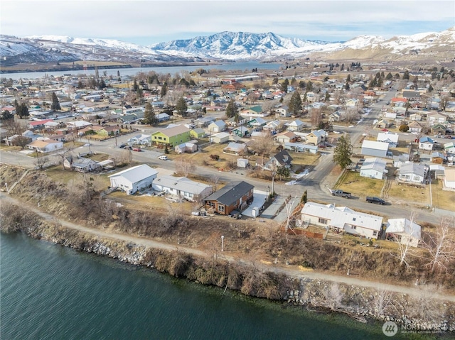 birds eye view of property with a water and mountain view