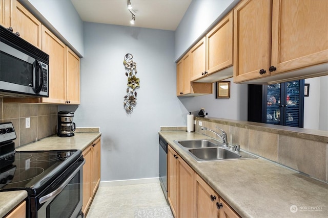 kitchen featuring light brown cabinetry, sink, backsplash, and stainless steel appliances