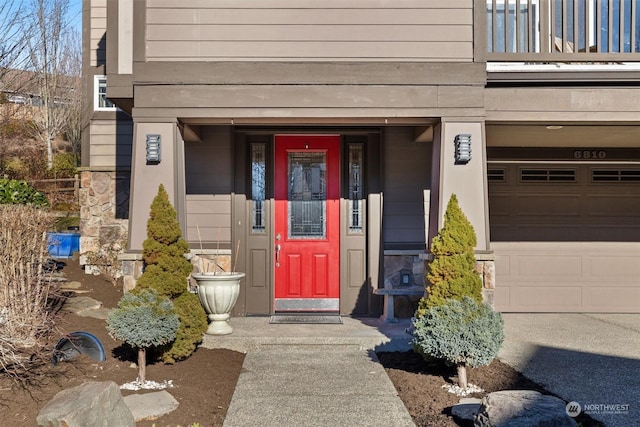 doorway to property with a garage and a balcony