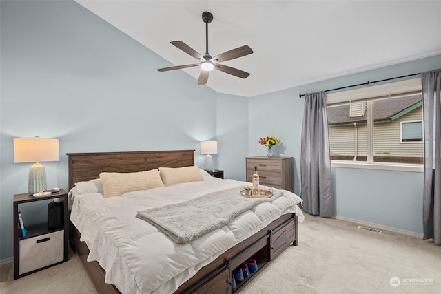 bedroom with ceiling fan, vaulted ceiling, and light carpet