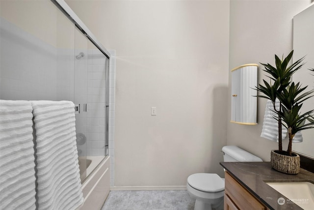 full bathroom featuring enclosed tub / shower combo, vanity, and toilet