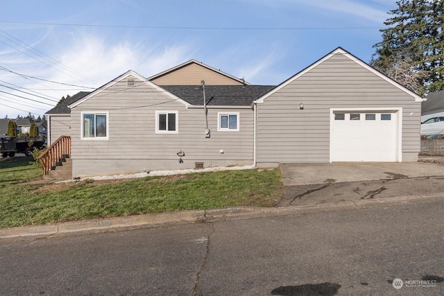 view of side of property with a yard and a garage