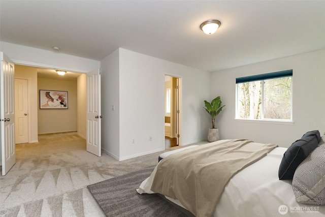 bedroom with light carpet and baseboards