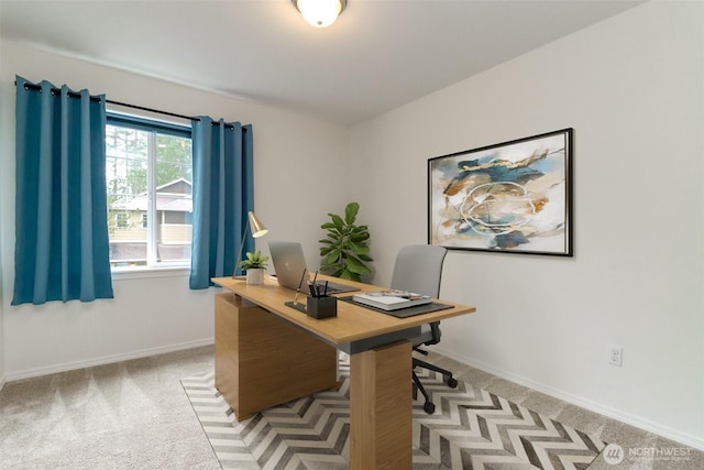 office space with light carpet and baseboards