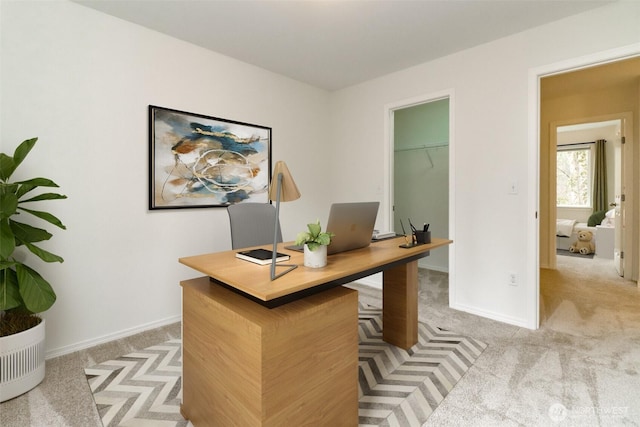 office with light carpet and baseboards