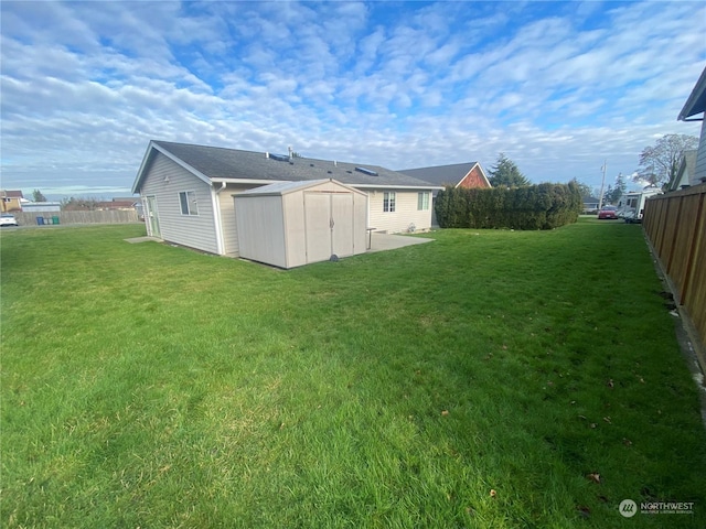 rear view of property with a storage shed and a yard