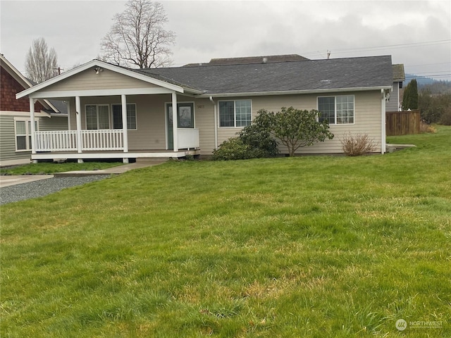 ranch-style house featuring a front lawn and covered porch