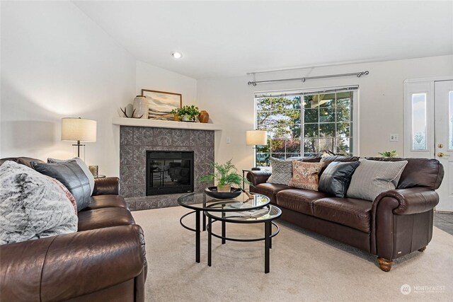 carpeted living room featuring a fireplace