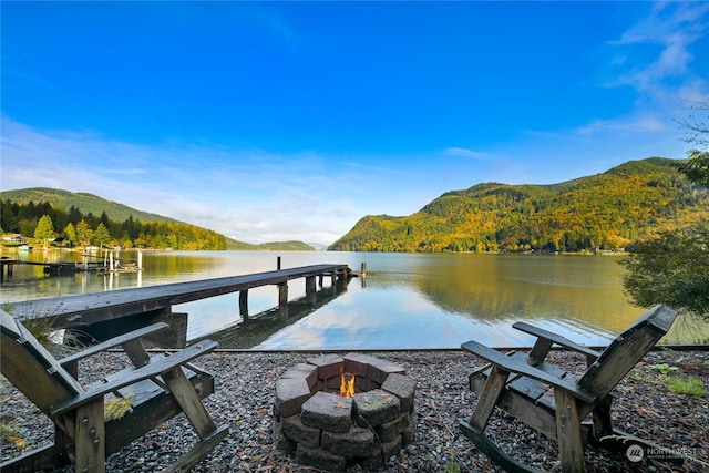 dock area featuring a water and mountain view and an outdoor fire pit