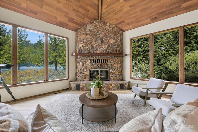 living room with a stone fireplace, light wood-type flooring, wood ceiling, and high vaulted ceiling