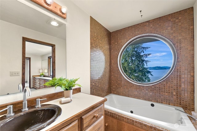 bathroom featuring vanity and a tub