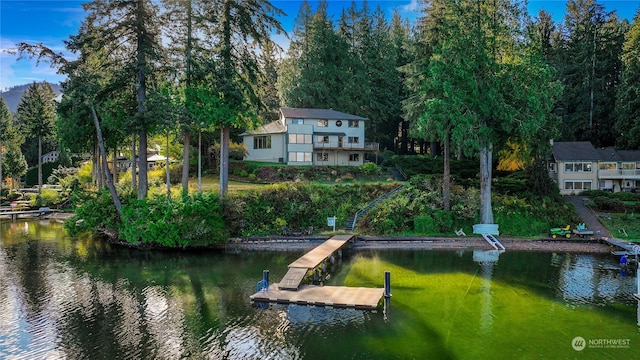 dock area with a water view and a balcony