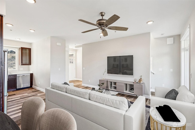 living room with ceiling fan and light hardwood / wood-style floors