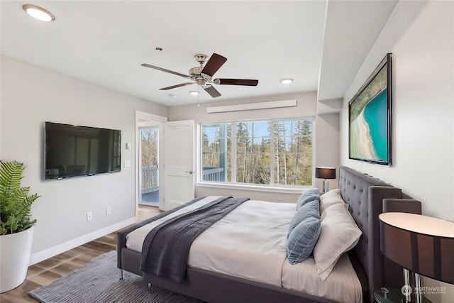 bedroom with ceiling fan and dark hardwood / wood-style floors