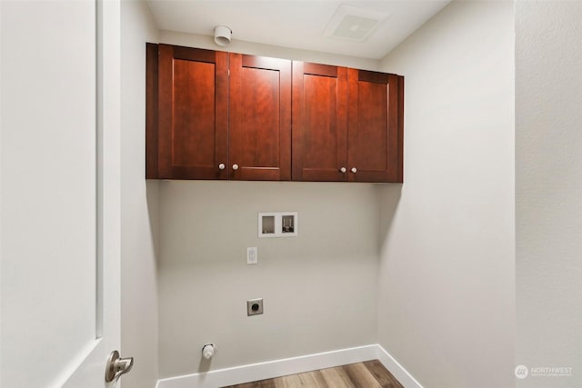 laundry area with cabinets, hookup for an electric dryer, light hardwood / wood-style floors, and hookup for a washing machine