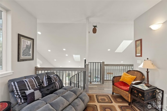 living room with hardwood / wood-style floors and a skylight