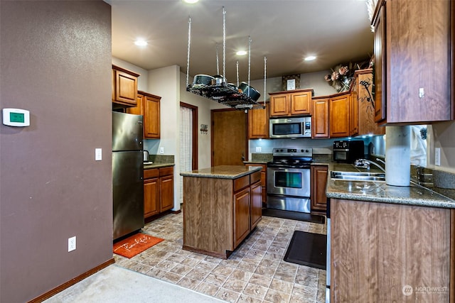 kitchen with sink, stainless steel appliances, and a kitchen island