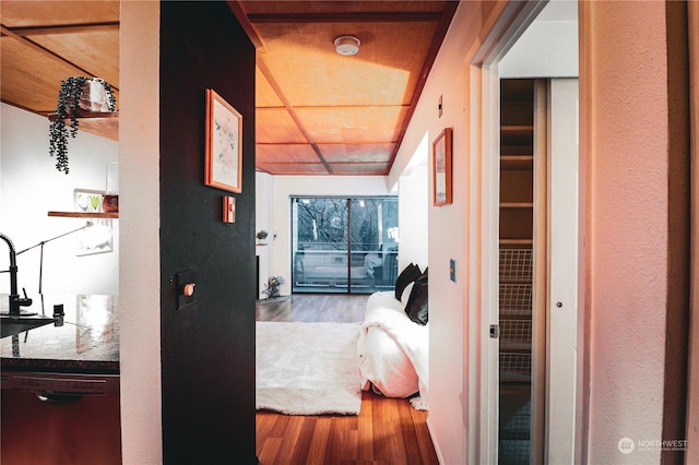 hall with sink and wood-type flooring