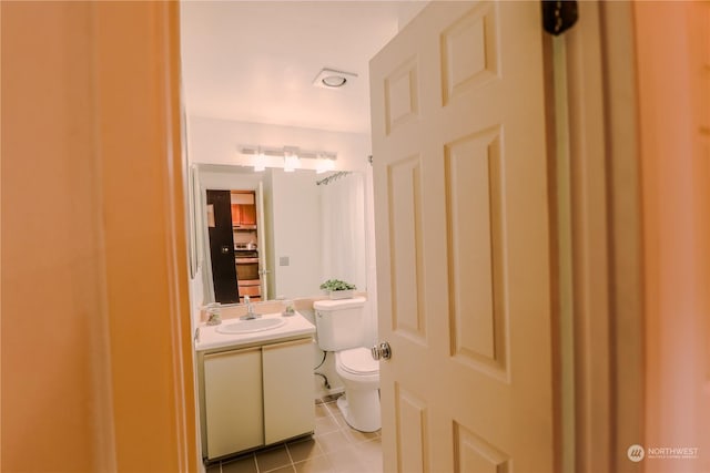 bathroom featuring vanity, toilet, and tile patterned flooring