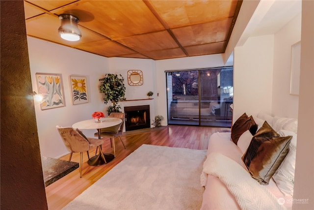 living room featuring wood-type flooring and wood ceiling