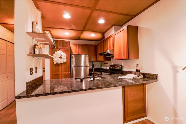 kitchen featuring range with electric stovetop, dark stone countertops, stainless steel fridge, and kitchen peninsula