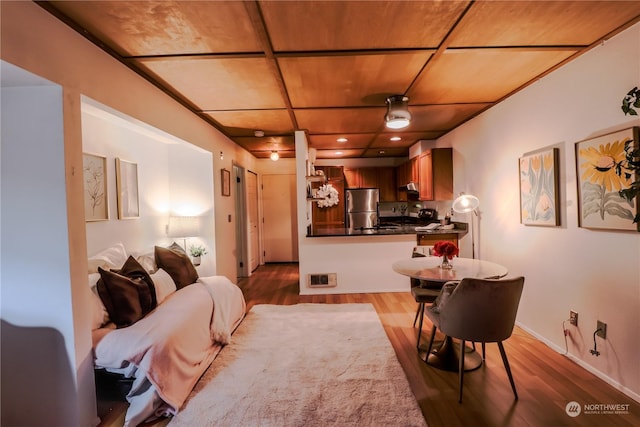 interior space with wooden ceiling and light hardwood / wood-style flooring