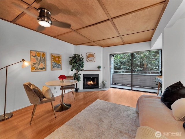 211 Summit Ave E Unit N308, Seattle, WA 98102 - living area with wood finished floors, a warm lit fireplace, a ceiling fan, and wood ceiling