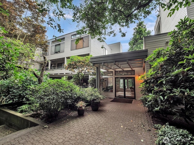 211 Summit Ave E Unit N308, Seattle, WA 98102 - rear view of house featuring french doors and a patio area