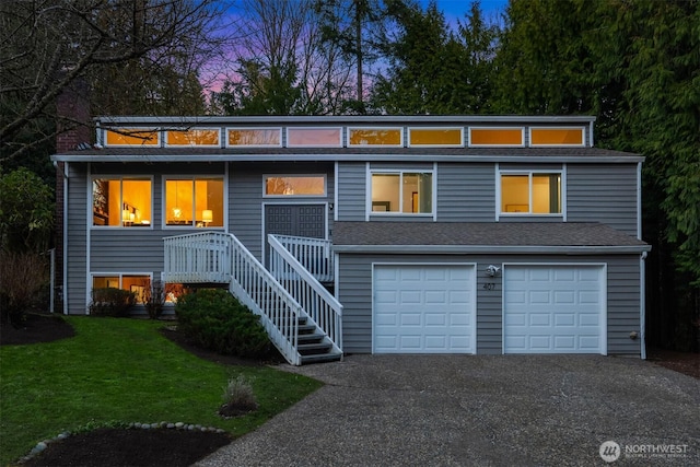 view of front of house with a garage and a lawn