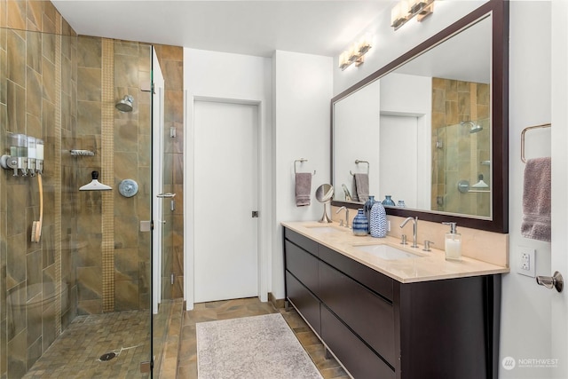 bathroom featuring vanity and a shower with door