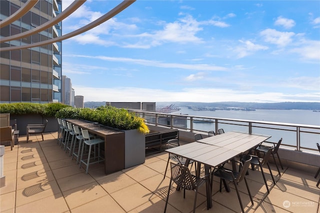 view of patio / terrace featuring a water view and an outdoor bar