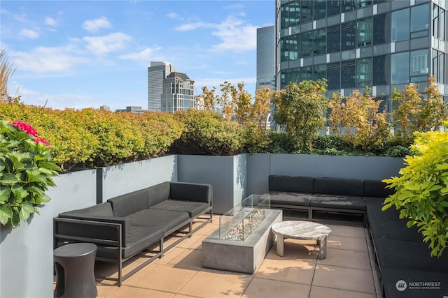 view of patio / terrace featuring an outdoor living space with a fire pit