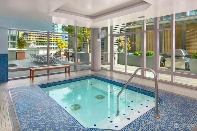 view of pool with grilling area, an indoor hot tub, and a patio