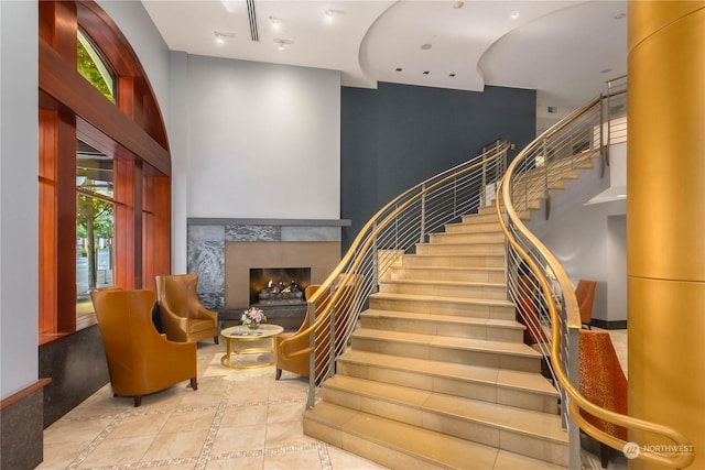 staircase featuring plenty of natural light and tile patterned floors