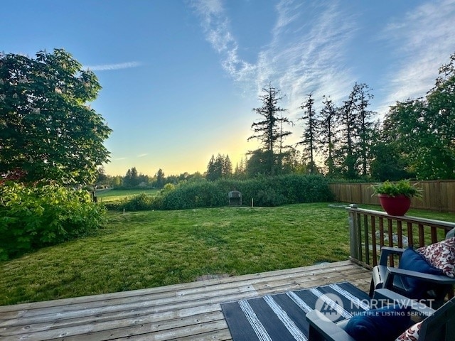 yard at dusk with a deck