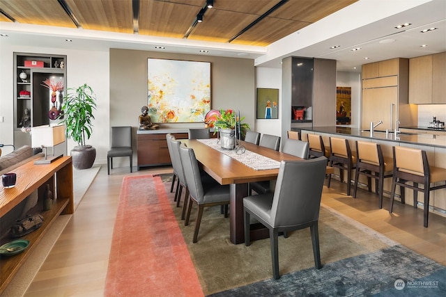 dining space with light hardwood / wood-style flooring