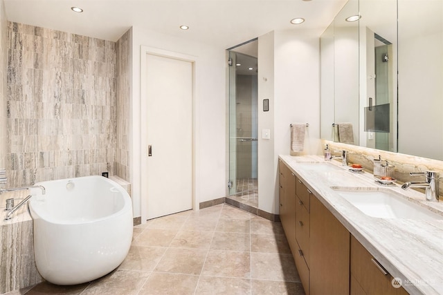 bathroom featuring vanity, shower with separate bathtub, and tile patterned flooring