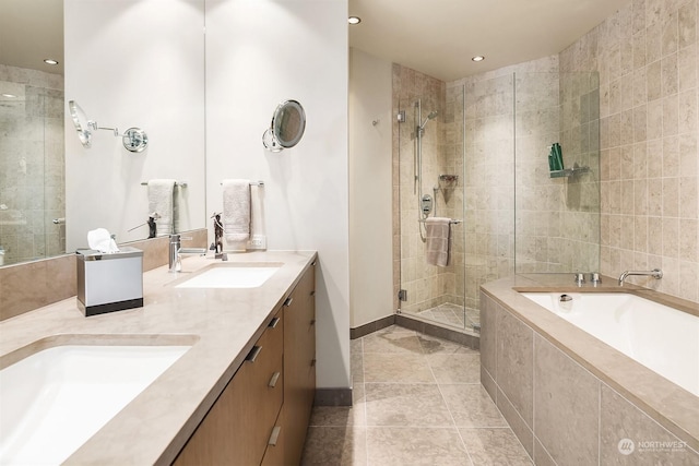 bathroom with plus walk in shower, tile patterned floors, and vanity